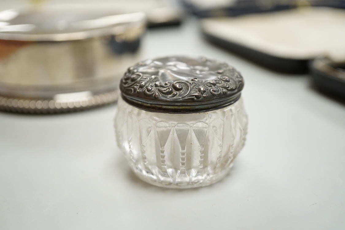 A Portuguese white metal 916 standard circular box and cover, retailed by Joalharia Do Carmo, diameter 94mm, together with cased set of six silver plated coffee spoons, a cased silver teaspoons, a Victorian silver christ